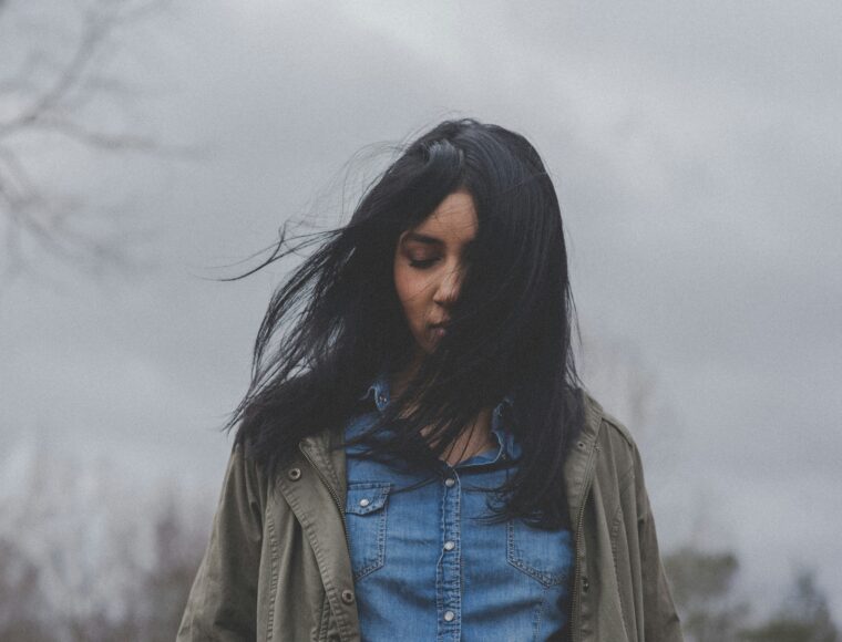 Image of a woman walking on a cloudy afternoon