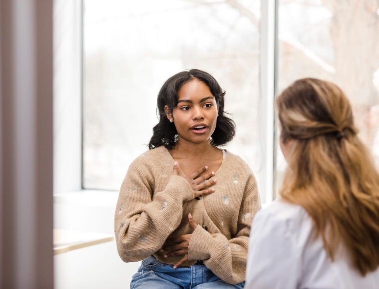 Young woman talking to a female member of staff