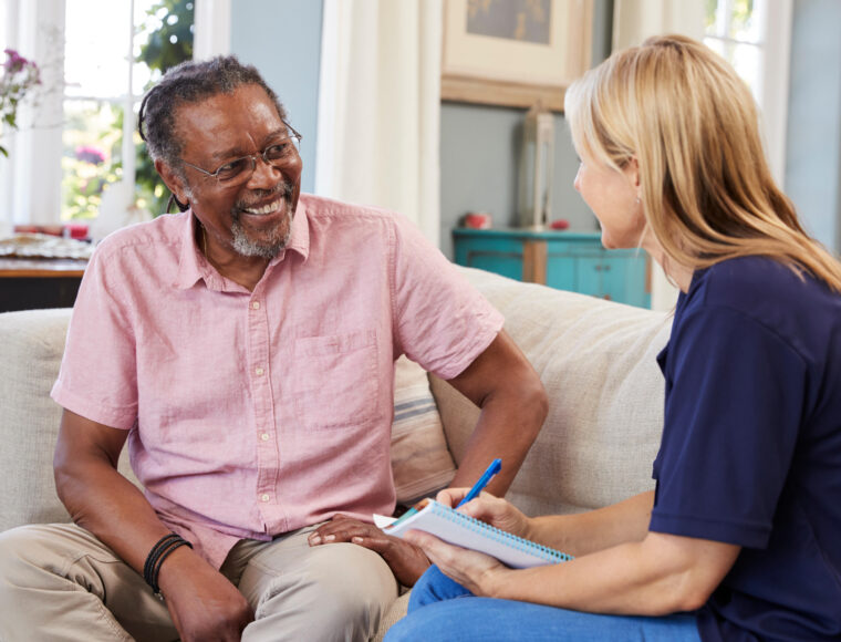 Female support worker visiting an an older man at home