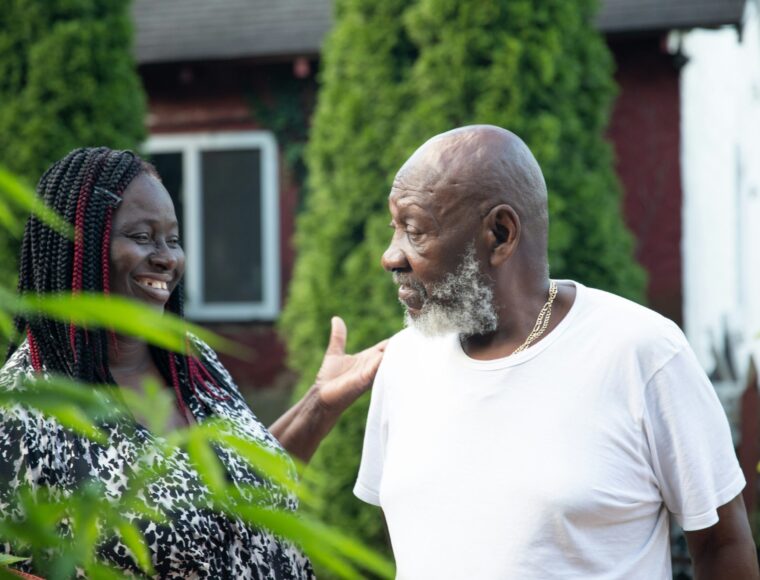 two adults walking and talking outdoors
