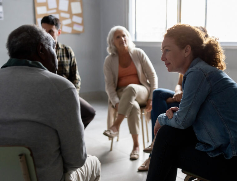 People sharing stories in a group therapy session