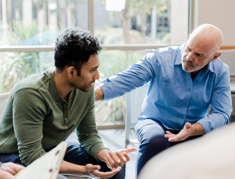 Mature man helps younger man verbalize problems in therapy