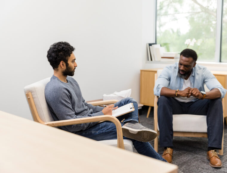 Male therapist waits patiently for a adult male to gather his thoughts and share what is on his mind.