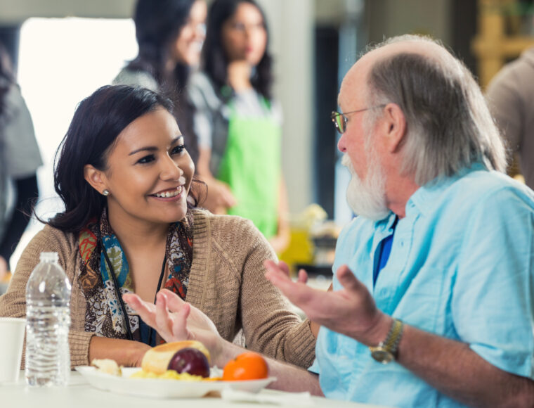 Young woman talking to a participant in a community setting