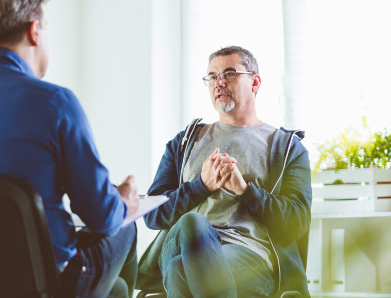 Mature man talking with visiting professional