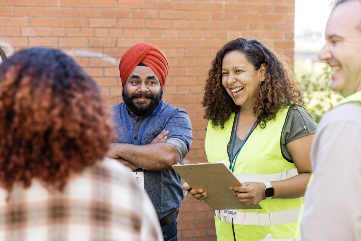 Community outreach worker speaks to a group of people